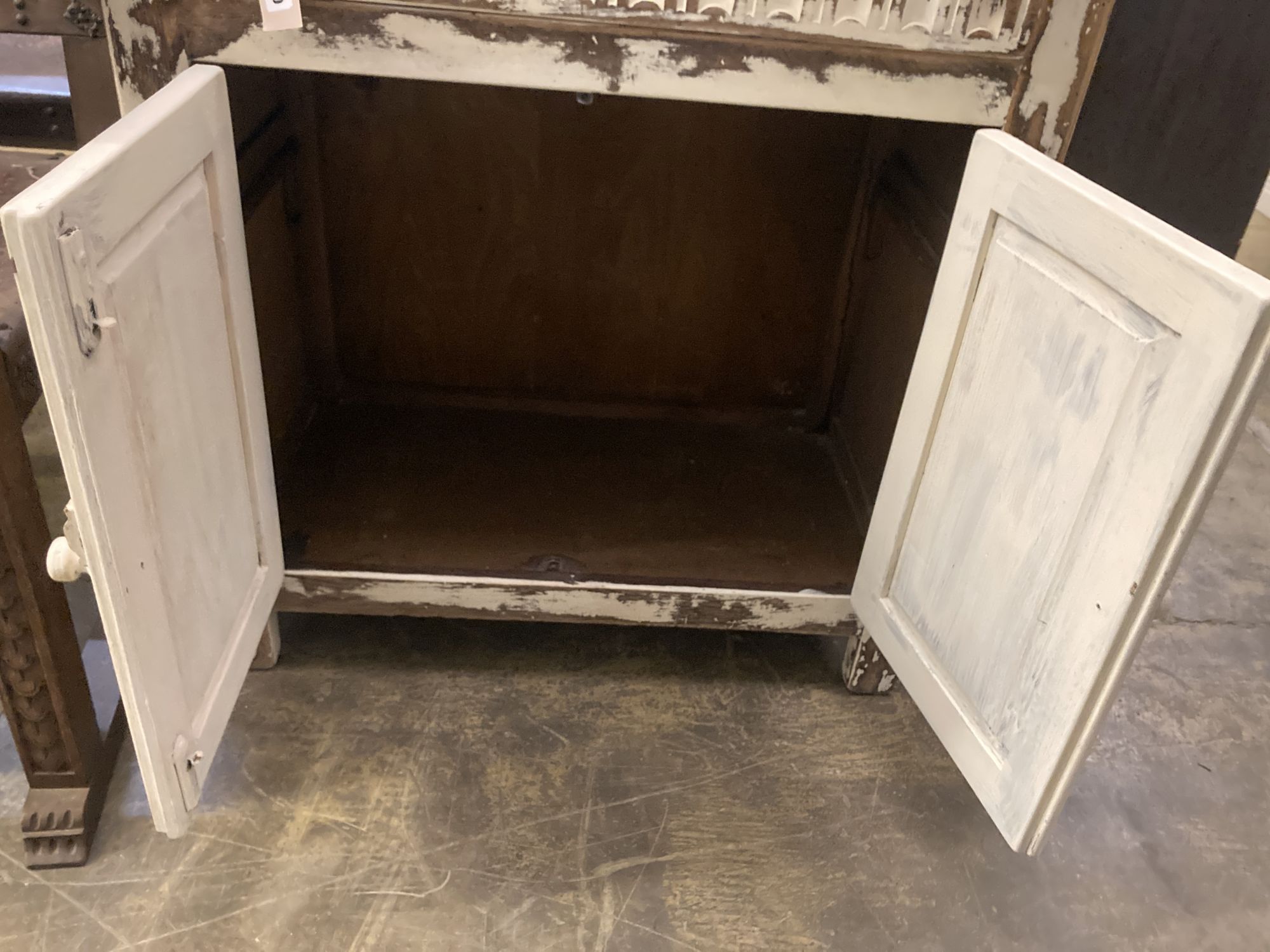 A 1920s oak narrow dresser with distressed paintwork, width 76cm, depth 42cm, height 175cm